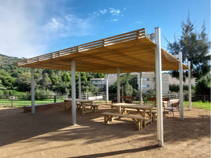 Combination of four pergola modules creating a picnic area